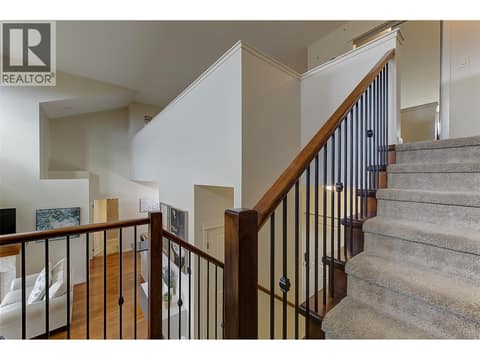 Open spindled staircase to mezzanine 2nd floor at 2142 Vasile Road Unit# #409, Springfield/Spall, Kelowna