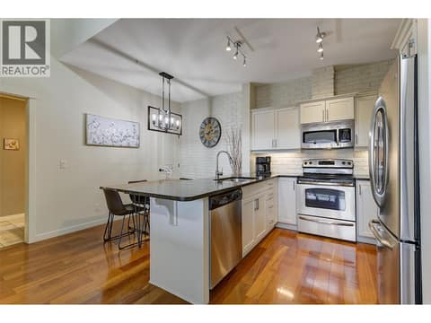 Refreshed white kitchen with quartz counters and SS appliances at 2142 Vasile Road Unit# #409, Springfield/Spall, Kelowna