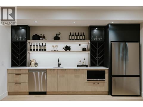 A fully equipped basement rec room featuring a dishwasher, microwave, and fridge at 5533 Foothill Court, Kettle Valley, Kelowna