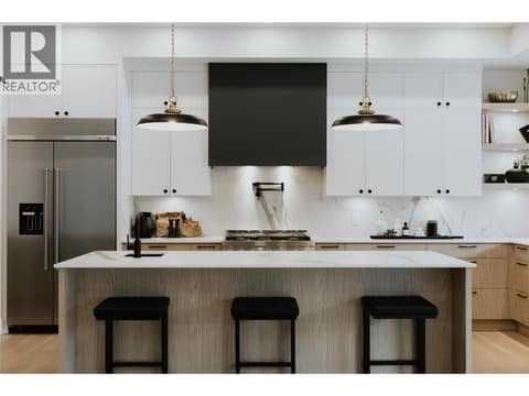 Exquisitely designed kitchen featuring Dekton countertops and backsplash, renowned for their durability. at 5533 Foothill Court, Kettle Valley, Kelowna