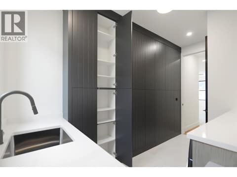 Stylish wall of storage in laundry room at 5533 Foothill Court, Kettle Valley, Kelowna