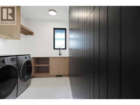 Well-designed laundry room with a functional layout and ample storage space at 5533 Foothill Court, Kettle Valley, Kelowna