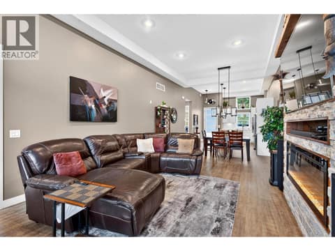 Living Room 12 ft ceilings electric fireplace rock surround at 9700 Santina Road Unit# 14, Lake Country North West
