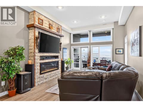 Living Room with Electric fireplace (2 stage heat) and custom rock surround with TV mount at 9700 Santina Road Unit# 14, Lake Country North West
