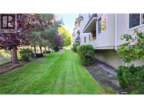Green Space Rear Of Building at 255 Aurora Crescent Unit# 204, Rutland North, Kelowna