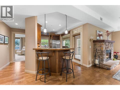 Hand-scraped engineered hardwood flooring. AI enhanced flames. at 2780 Auburn Road Unit# 203, Shannon Lake, West Kelowna