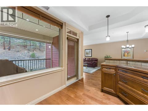 Kitchen access to the covered deck. at 2780 Auburn Road Unit# 203, Shannon Lake, West Kelowna