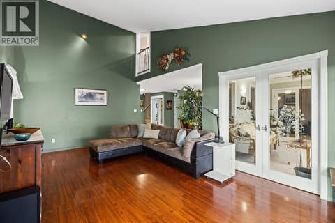 Living room/door to sunroom at 3219 Sagebrush Court, Shannon Lake, West Kelowna