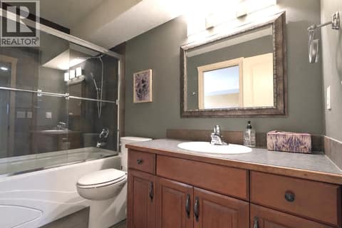 Bathroom Down with Cheater Door from Bedroom #3 at 1950 Capistrano Drive Unit# 108, University District, Kelowna