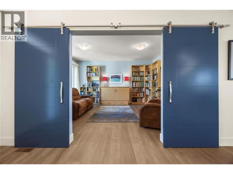 Barn door entrance to main floor den/flex space at 2442 Bella Vista Street, Black Mountain, Kelowna