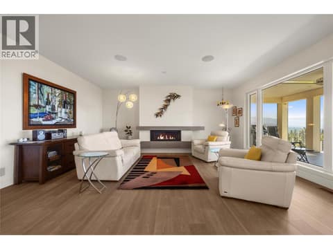 Featuring a linear gas fireplace at 2442 Bella Vista Street, Black Mountain, Kelowna