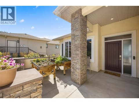 Front courtyard with flower beds at 2442 Bella Vista Street, Black Mountain, Kelowna