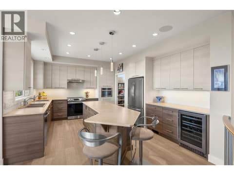 Generous sized kitchen featuring a sit up island and 2 toned cabinetry at 2442 Bella Vista Street, Black Mountain, Kelowna