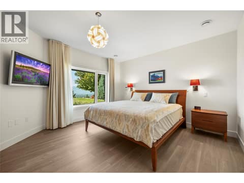 Lower level Primary bedroom with lake views at 2442 Bella Vista Street, Black Mountain, Kelowna