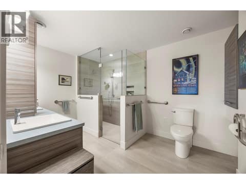 PRIMARY 4 PC ENSUITE: Elegant ensuite with dual sinks, curbless walk-in shower with custom tile surround and glass door, plus heated tile flooring at 2442 Bella Vista Street, Black Mountain, Kelowna