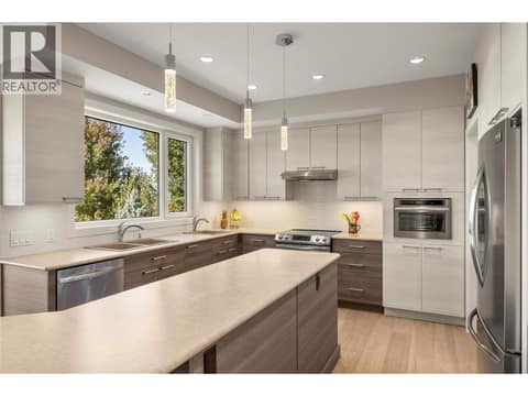 The kitchen includes all SS appliances plus a 24” Jennair steam oven that can also be used as a second convection oven at 2442 Bella Vista Street, Black Mountain, Kelowna