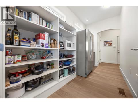 Walk through pantry with built in shelves and second fridge at 2442 Bella Vista Street, Black Mountain, Kelowna