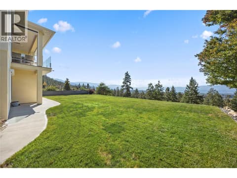 West-facing backyard with expansive lake, valley and mountain views & a large grassy area at 2442 Bella Vista Street, Black Mountain, Kelowna