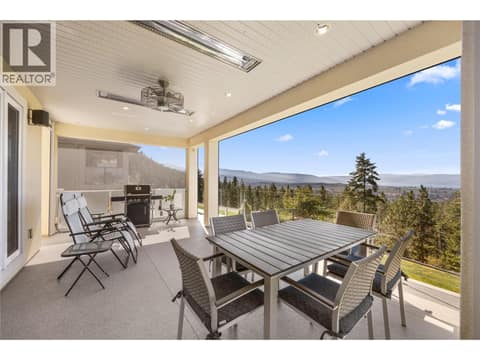 Year-round entertaining space with retractable motorized screens, glass railings, natural gas hookup at 2442 Bella Vista Street, Black Mountain, Kelowna