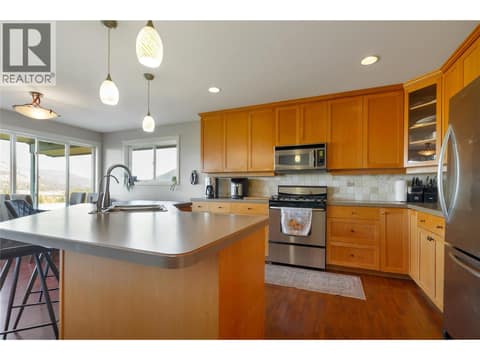 Kitchen features maple cabinets and island at 110 Red Rock Crescent, Enderby / Grindrod