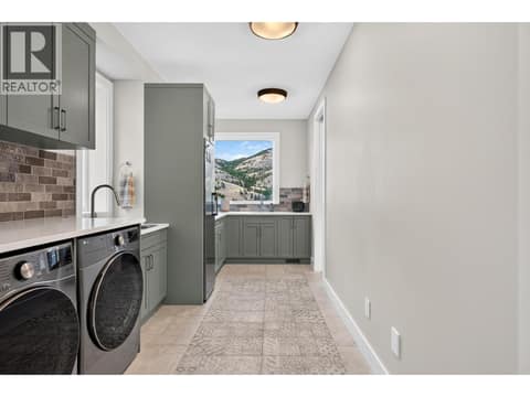 Butler's pantry with laundry at 887 Loseth Drive, Black Mountain, Kelowna