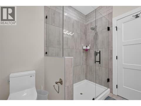 Primary ensuite with a fully tiled glass shower and modern finishes. at 2400 Hawks Boulevard, Westbank Centre, West Kelowna