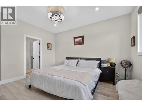 Spacious primary bedroom with a walk-in closet and private ensuite. at 2400 Hawks Boulevard, Westbank Centre, West Kelowna