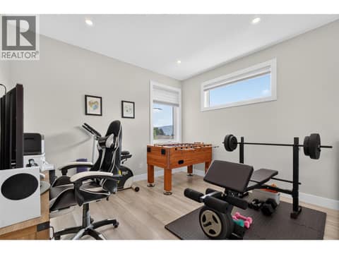 Versatile upstairs bonus space — perfect for a home office, playroom, gym or second living area at 2400 Hawks Boulevard, Westbank Centre, West Kelowna