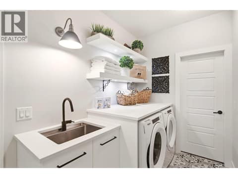 Laundry off the Primary Closet + mudroom at 1675 Willow Crescent Unit# 3 Lot# 3, Glenmore, Kelowna