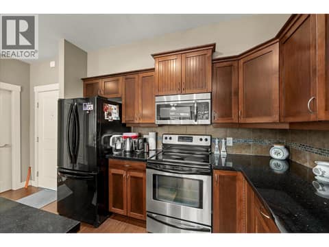Beautiful kitchen with black granite counters. at 3545 Carrington Road Unit# 108, Westbank Centre, West Kelowna