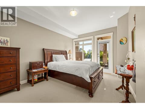 Primary bedroom boasts a walk out to the patio. at 3545 Carrington Road Unit# 108, Westbank Centre, West Kelowna