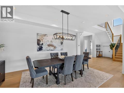 Elegant dining area with soaring ceilings and a statement light fixture. at 1531 Cabernet Way, Lakeview Heights, West Kelowna