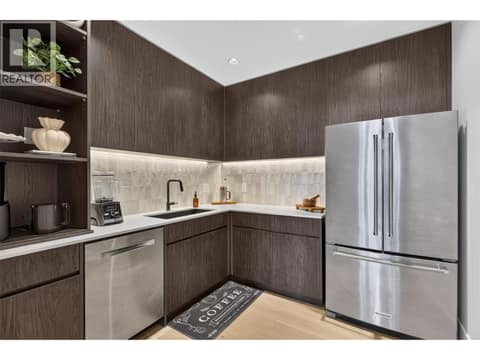 Hidden walk in pantry with extensive cabinetry, prep sink and full size refrigerator. at 1531 Cabernet Way, Lakeview Heights, West Kelowna