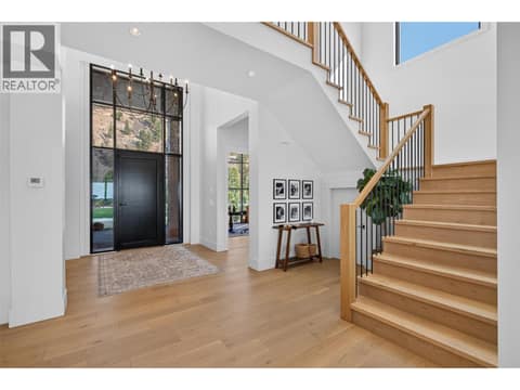Impressive two storey foyer with a dramatic chandelier and modern staircase. at 1531 Cabernet Way, Lakeview Heights, West Kelowna