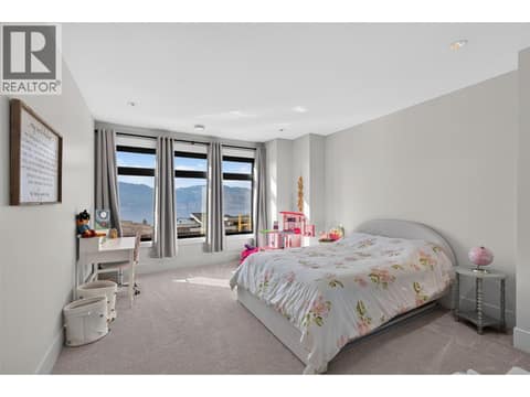 One of five spacious upper level bedrooms with beautiful lake views. at 1531 Cabernet Way, Lakeview Heights, West Kelowna
