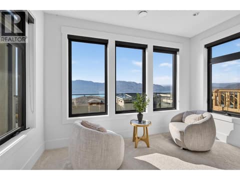 Private sitting area in the primary bedroom with beautiful lake and mountain views. at 1531 Cabernet Way, Lakeview Heights, West Kelowna