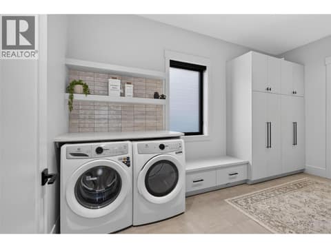 Spacious mudroom room with laundry, custom cabinetry and abundant storage. at 1531 Cabernet Way, Lakeview Heights, West Kelowna