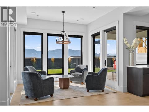 Sun filled sitting area with large windows framing beautiful mountain views. at 1531 Cabernet Way, Lakeview Heights, West Kelowna
