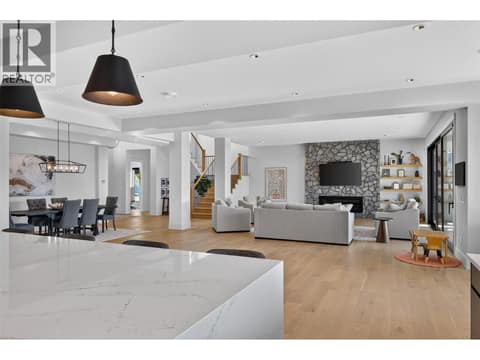 The expansive main level features soaring ceilings and a striking fireplace. at 1531 Cabernet Way, Lakeview Heights, West Kelowna