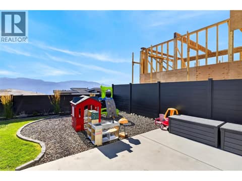 Versatile backyard play area with potential for a cozy fire pit space. at 1531 Cabernet Way, Lakeview Heights, West Kelowna