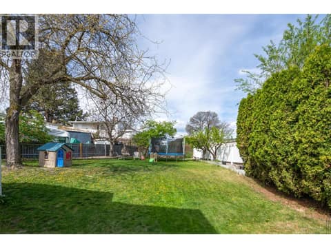 Left side yard. Lots of room at 1360 Elm Street, Glenmore, Kelowna