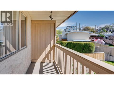 Balcony off primary bedroom overlooking backyard. at 3906 Pleasant Valley Road Unit# 23, Harwood, Vernon