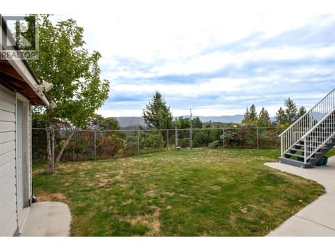 Fenced backyard with access to upper deck plus a storage shed at 2280 Shannon Hills Drive, Shannon Lake, West Kelowna