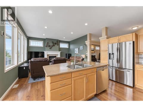 Kitchen to family room with gas fireplace at 2280 Shannon Hills Drive, Shannon Lake, West Kelowna