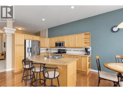 Kitchen with island and stainless steel appliance (gas stove) at 2280 Shannon Hills Drive, Shannon Lake, West Kelowna