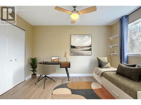 Virtually staged second bedroom. Could be an office or a den because of the french doors. at 505 Browne Road Unit# 103, City of Vernon