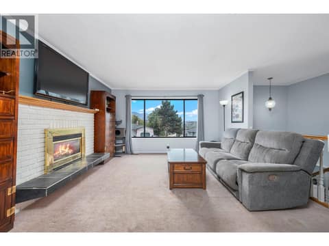 Main floor living room with gas fireplace at 2105 20 Avenue, East Hill, Vernon