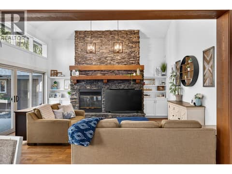 Great room with soaring ceilings and a dramatic floor to ceiling stone fireplace. at 178 Terrace Hill Court, Wilden, Kelowna