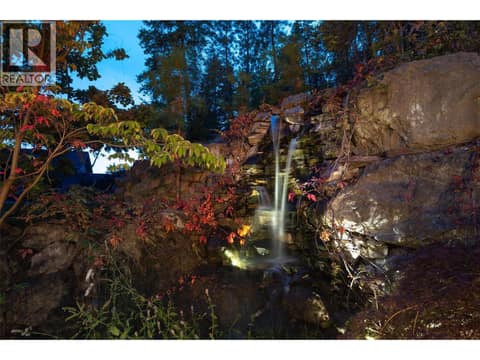 Stunning waterfall feature beautifully integrated into the natural rock landscape. at 178 Terrace Hill Court, Wilden, Kelowna