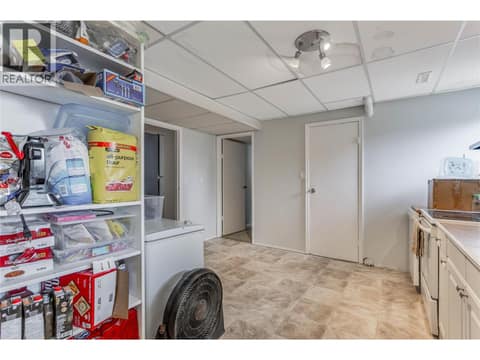 Kitchen on lower level. Door to one of the lower level bedrooms at the rear right. at 3341 Webber Road, Glenrosa, West Kelowna